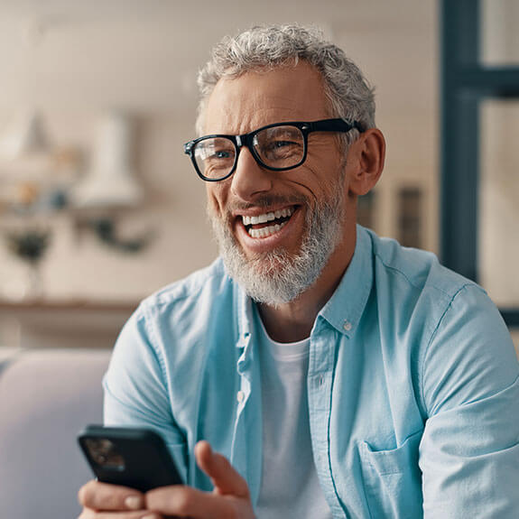 happy-older-man-with-phone